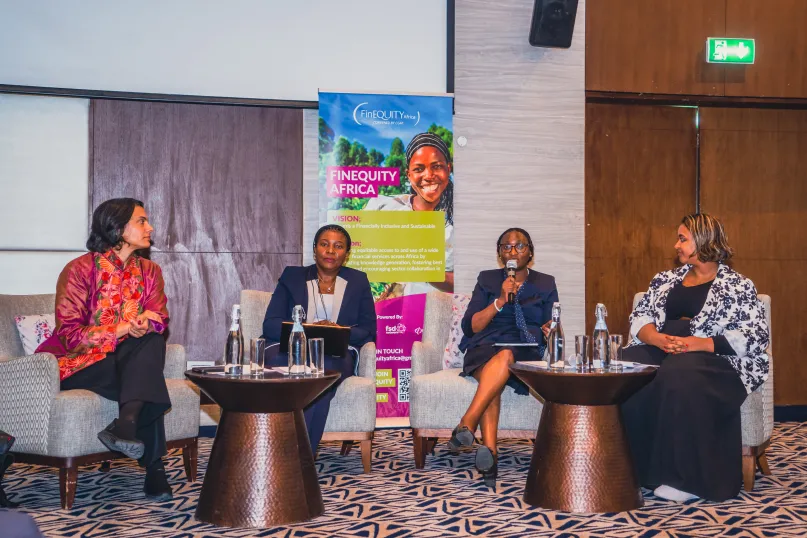 Women discussing at event.