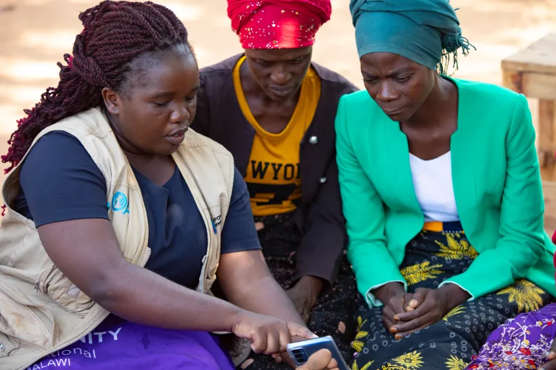 Women being trained how to access digital financial services. 