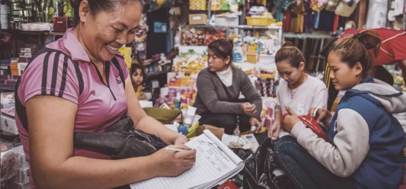 Market seller writing down orders for three customers