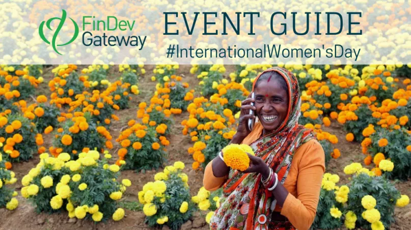 Woman on mobile phone in orange and yellow marigold field.