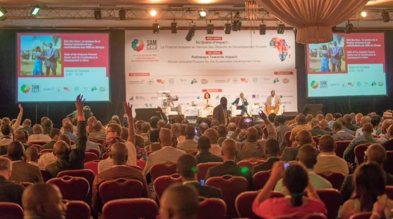 Audience with people raising their hands at SAM Conference. Photo by Jean-Claude Frisque.