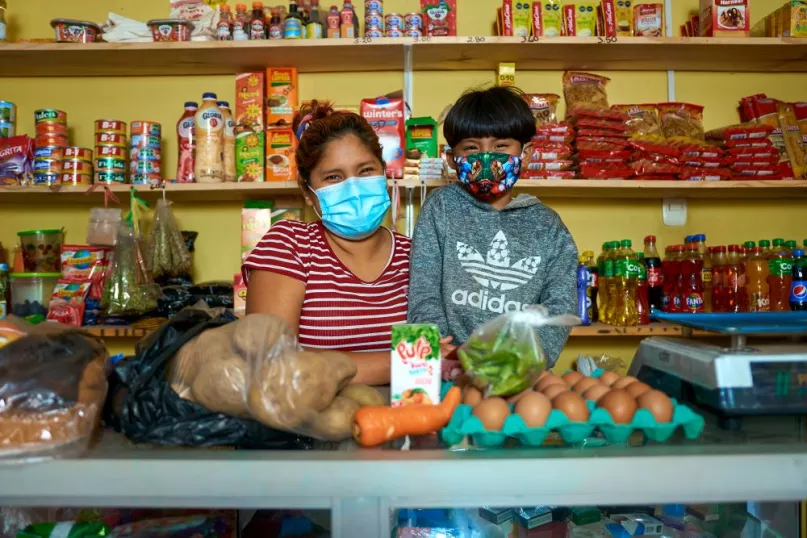 Photo of entrepreneur and child in shop.