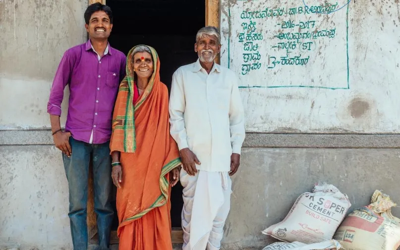 Standing outside the home they are building with the help of a microloan, India. Habitat for Humanity photo by Annalise Kaylor.