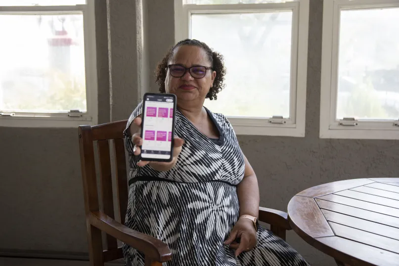 Woman holding mobile device.