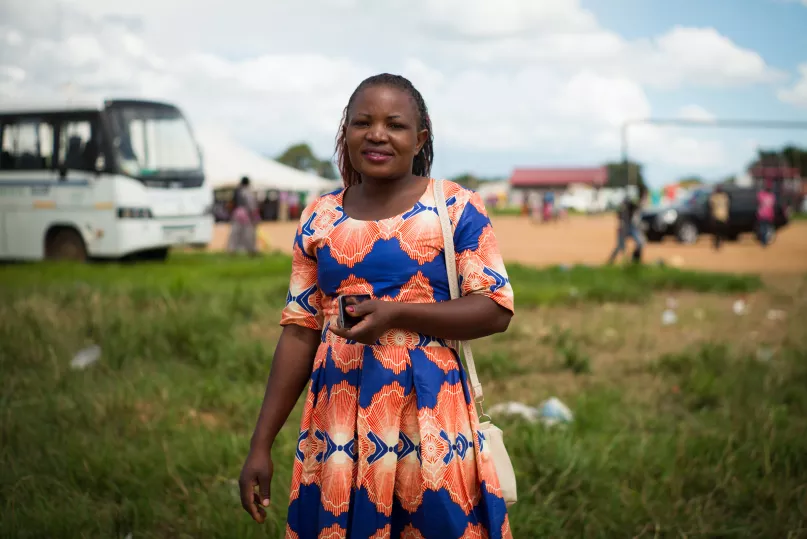 Magdalene, a primary school teacher and mother, is part of a women's lending circle and regularly uses digital financial services on her mobile phone. Photo by Caroline Gutman, 2018 CGAP Photo Contest.