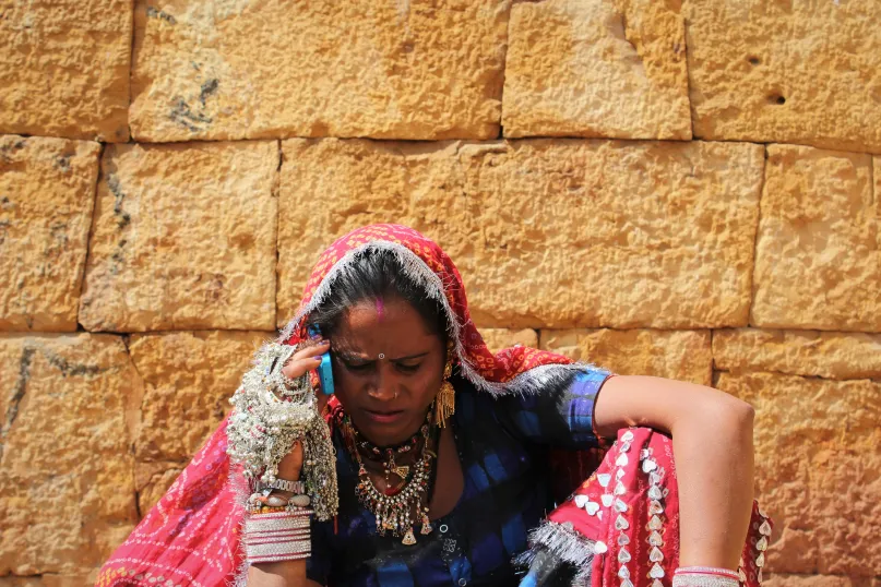 Woman conducting business on mobile phone, India. Photo credit: Chara Lata Sharma, 2017 CGAP Photo Contest.