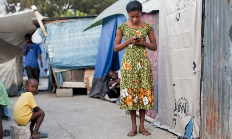 Woman with mobile phone. Photo credit: Bill & Melinda Gates Foundation 2012.