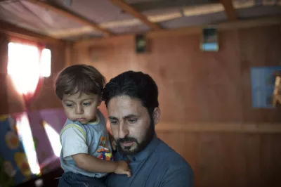 A man holding his son. Photo by Dominic Chavez, World Bank.