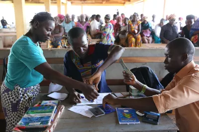 Recieving cash transfer payment. Photo by Dominic Chavez, World Bank.