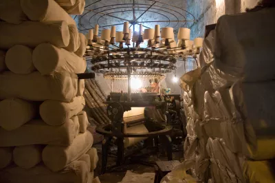 A man creates cotton products using a knitting machine. Photo by Kushal Gangopadhyay, 2010 CGAP Photo Contest.