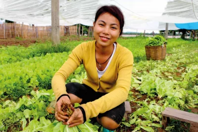 A young farmer smiling at the camera