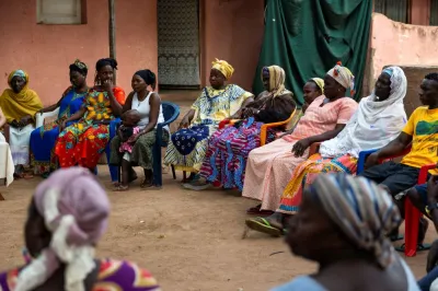 Group of women in Guinea-Bissau sitting at a community meeting.