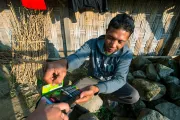 Man using a credit card terminal, Photo Credit: Ady Agustian, 2015 CGAP Photo Contest