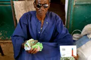 Man showing his savings. Photo Credit: Ashish Kumar, 2015 CGAP Photo Contest