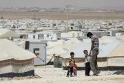 Man with children standing near a tent. Photo Credit: Dominic Chavez, World Bank