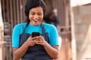 Woman holding cell phone and smiling