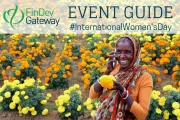 Woman on mobile phone in orange and yellow marigold field.