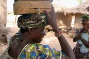 Woman carrying a container above her head