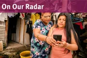 Two women in Colombia look at a phone together.