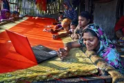 Women knitting sarees, India.