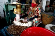 Woman wearing a mask, working at a machine. SPTF photo by Quang Nguyen Vihn.