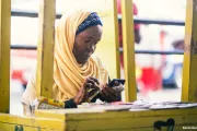 A woman uses her mobile phone in a city in Kenya.